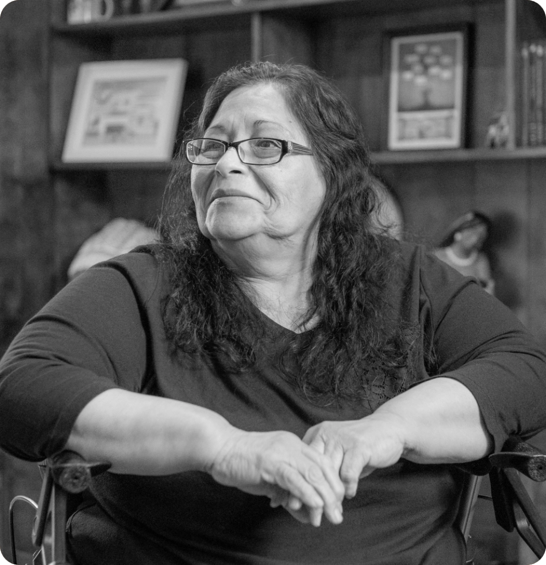 Black and white Image representing a member of the Pompe disease community, sitting contently.